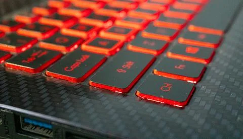Shift button visible on laptop's red keyboard light Stock Photos