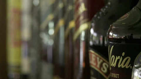 Shift focus through liquor bottles Stock Footage