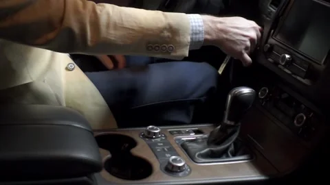 Shift knob and dashboard of the car. the man drives the engine Stock Footage 91829403