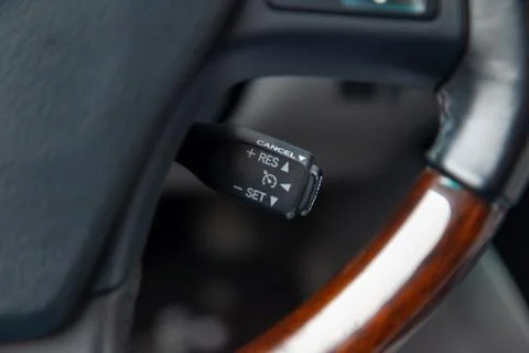 The shift lever to set the automatic cruise control speed inside the car clos Stock Photos