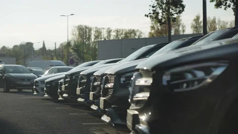 Shift which makes a dozen Mercedes cars appear with a sunset Stock Footage 233748921