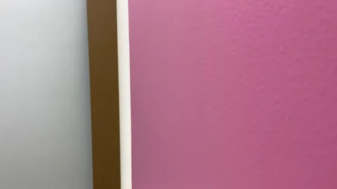 Shifting focus from grey wall background to pink wall texture close up view. Stock Footage 249873399