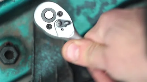 Shifting the wrench lever, and manually tighten the bolt with the wrench Stock Footage 150613642