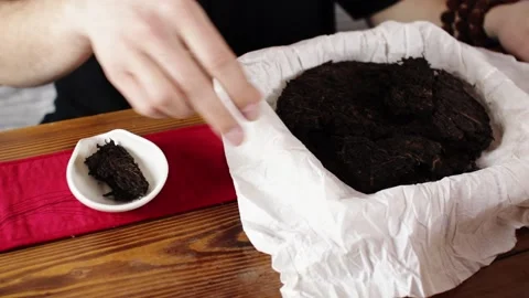 Shifts a serving of tea from a large tablet Stock Footage 139331495