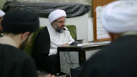 A Shiite scholar gives a lesson to students inside Hawza in Karbala, Iraq Stock Footage 148900529