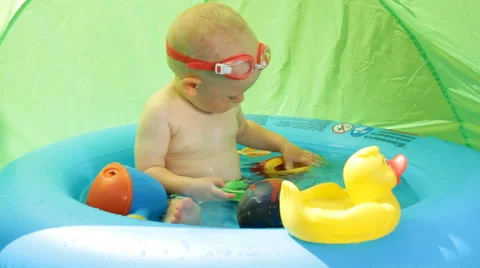 Shild Bathes in Baby Pool Video stock 64763882