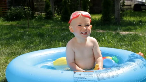 Shild Bathes in Baby Pool Stock Footage 64763899