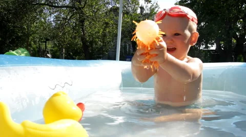 Shild Bathes in Baby Pool Stock Footage 64763967