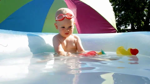 Shild Bathes in Baby Pool Stock Footage 64763973
