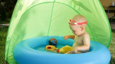 Shild Bathes in Baby Pool Stock Footage 64764520