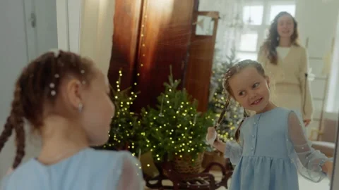Сhild removes snowflakes in front of a mirror. Holiday concept Stock Footage 321943178