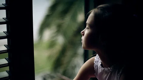 Сhild sitting on the window sill and looking out the window. Close up Stock Footage 39838462