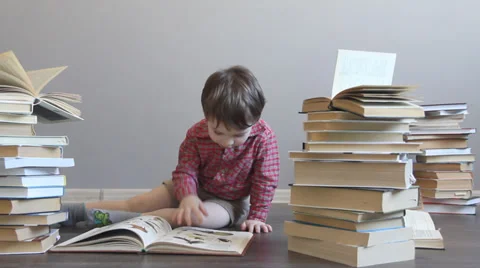 Сhild surrounded by books Video stock 37130615