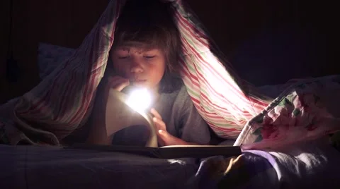 Сhildren read a book under the covers Stock-Footage 59901536