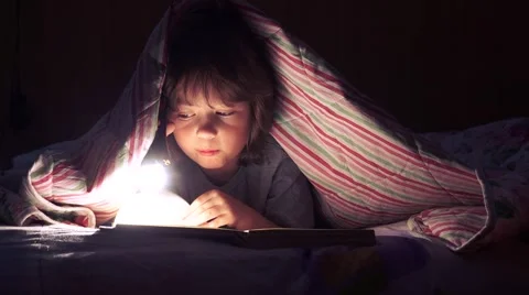 Сhildren read a book under the covers Stock-Footage 59924439