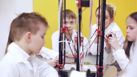 Сhildren stand around 3d printer and listen to the teacher Stock Footage 87166121