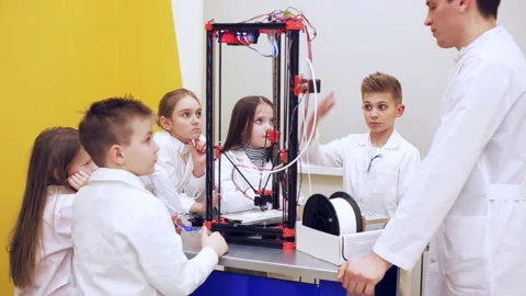 Сhildren stand around 3d printer and listen to the teacher Stock Footage 88267604