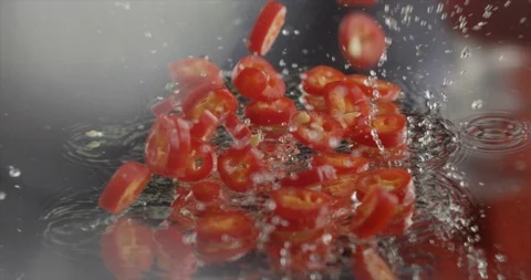 Сhilli and slices of chilli fall on glass in Slow motion (100fps, Few shots) Stock Footage 95250712