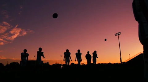Shilouetted Quarterbacks Warmup Stock Footage 34850717