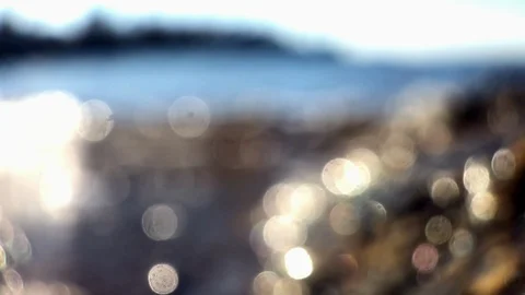 Shimmering calm suf as tide comes in sunshine macro defocus Stock Footage 100600770