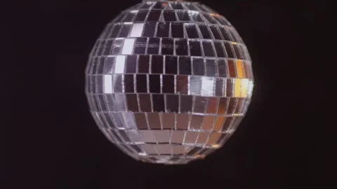 A Shimmering Disco Ball Rotating Gracefully in a Dark Background, Adding Magic Stock Footage 308885961