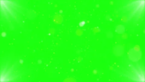 Shimmering golden dust particles floating against vibrant green screen 動画素材 344416927