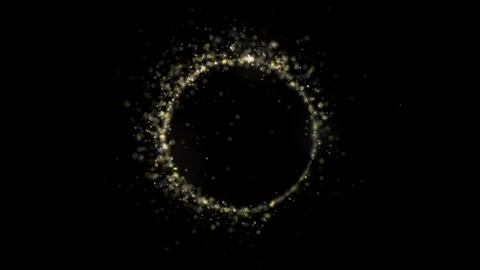 Shimmering golden particles form a circular frame against a deep black 库存影片 342700560