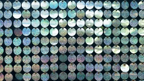 Shimmering holographic sequins creating a vibrant, reflective mosaic background, Stock Footage 329099858
