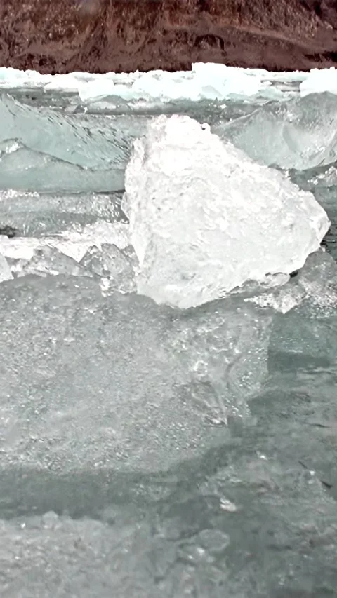 Shimmering Ice Fragments Drift on Captivating Arctic Currents Stock Footage 340483216