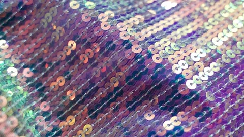 Shimmering iridescent sequin fabric sparkling in soft light with gentle movement Stock Footage 346397713
