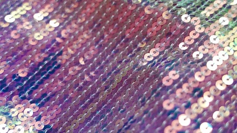 Shimmering iridescent sequin fabric sparkling in soft light with gentle movement Stock Footage 346397859