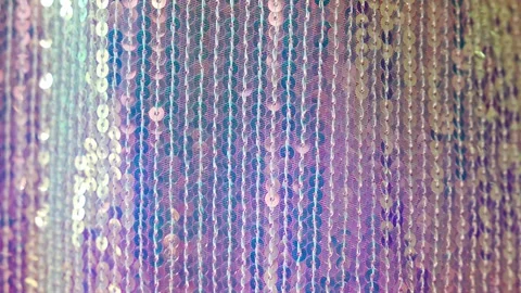 Shimmering iridescent sequin fabric sparkling in soft light with gentle movement Stock Footage 346397888