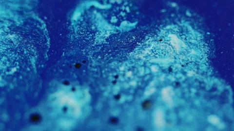 Shimmering paint background ink flow blue black Video stock 256193304