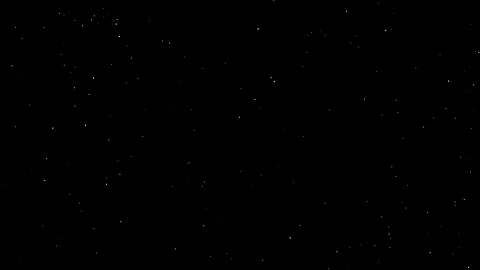 Shimmering particles fly in slow motion in the air on black background Stock Footage 171019724