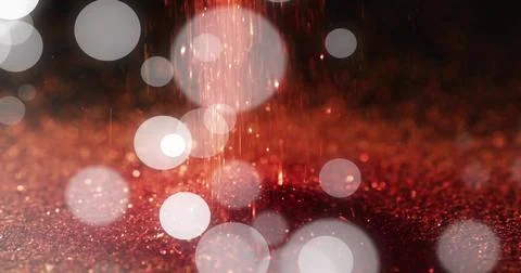 Shimmering red glitter surface glowing in studio close-up, with falling streaks Stock Illustration