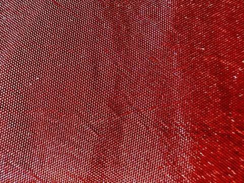 Shimmering red sequin texture closeup on fabric with sparkling dots for festive  Stock Photos