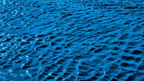 Shimmering reflections on blue water surface in slow motion. 4K video footage  Stock Footage 307012412