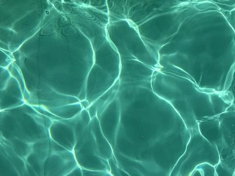 Shimmering Sunlight on Turquoise Pool Surface Stock Photos