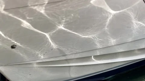 Shimmering Water Reflections on a White Boat Hull Stock Footage 343753140