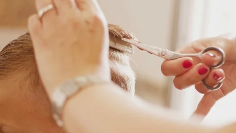 Shingling locks on nape by scissors, combing through hair Stock Footage 115643168