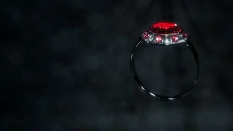 Shining dark metal ring with red ruby jewel rotate, fictive - loop video Stock Footage 193395618