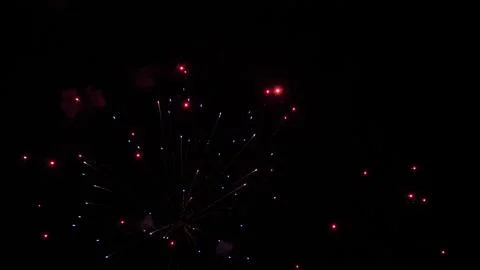 Shining firework explosion with bright colors in night sky at holiday party Foto stock