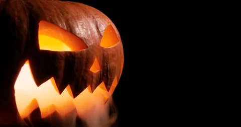 Shining Jack-O-Lantern. Halloween pumpkin with scary face smoke inside with Stock Footage 80141877