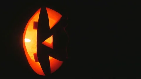 Shining Jack-O-Lantern. Halloween pumpkin on a black background.vertical screen Stock Footage 118216594