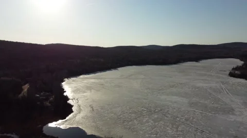 Shining Light Dark Forest and Frozen Lake Contrast Stock Footage 157933091