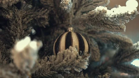 Shining lights on Christmas tree decorated with toys, glitter balls and snow Video stock 220094083