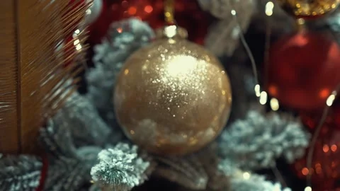 Shining lights on Christmas tree decorated with carnival-style toys and snow Video stock 220094424