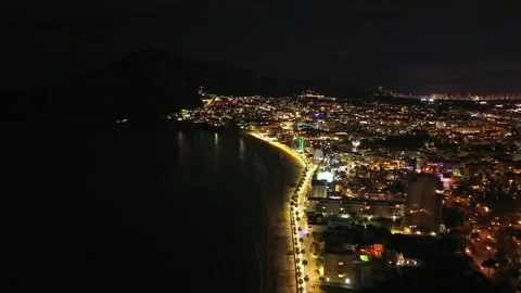 Shining shoreline under moonlight. Nighttime coast illuminated by lights with Stock Footage 342362471