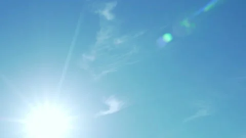 The Shining Sun Highlights the Rays of the Sun in a Blue Azure Sky with Light Ci Stock Footage 155432613