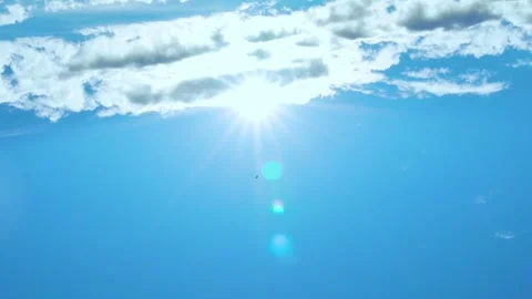 Shining Sun over white clouds in clear blue sky time lapse, motion. Glow, Sunlig Video stock 314648656